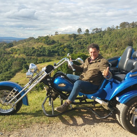 man riding on a blue motorbike