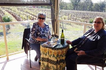 2 girls having a picnic in a winery farm