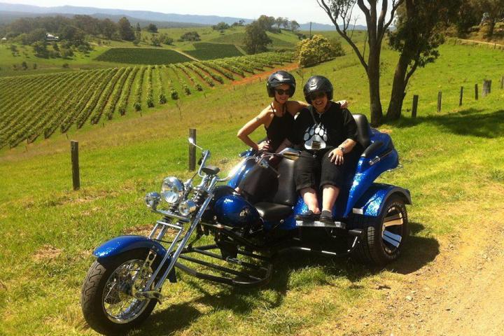 Couple riding a blue motorbike