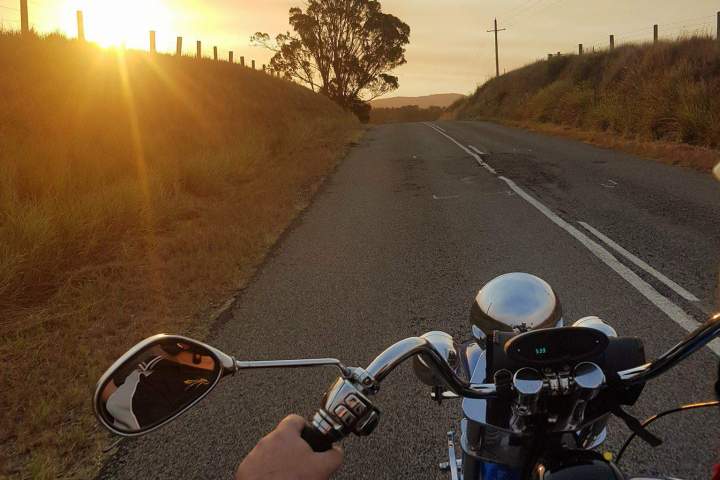 riding a motorbike during sunset