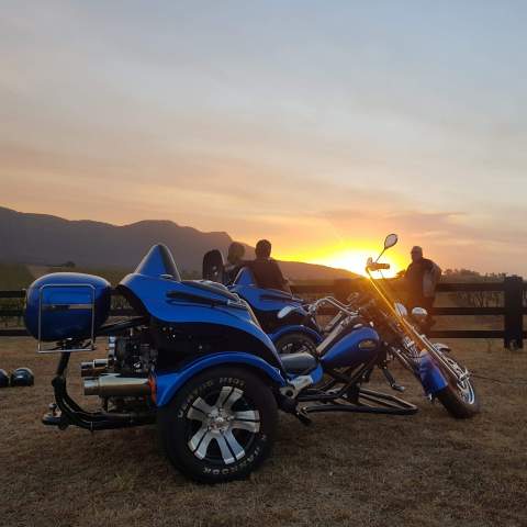 couple watching sunset on a motorbike