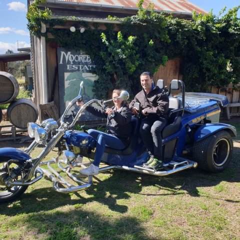 a group of people sitting on a motorcycle