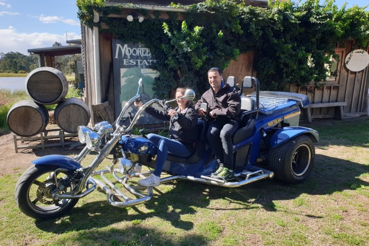 a group of people sitting on a motorcycle