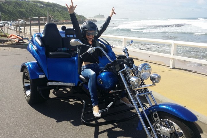 a person sitting on a blue motorcycle