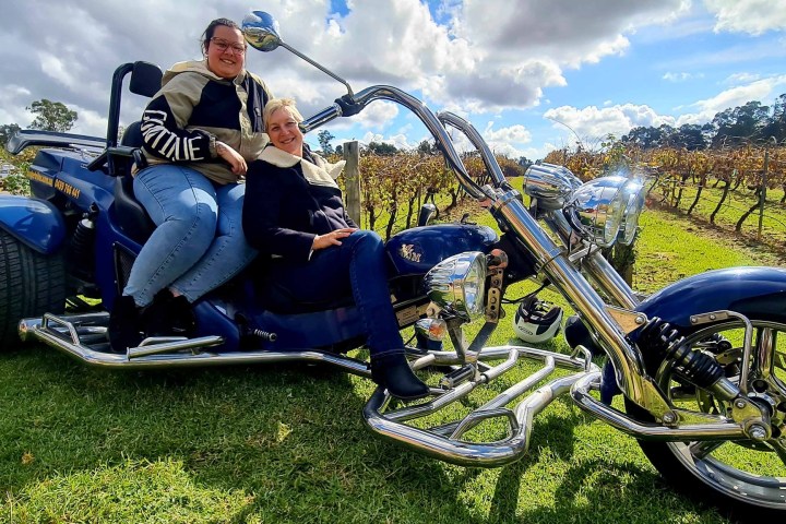 a person sitting on a motorcycle in a field